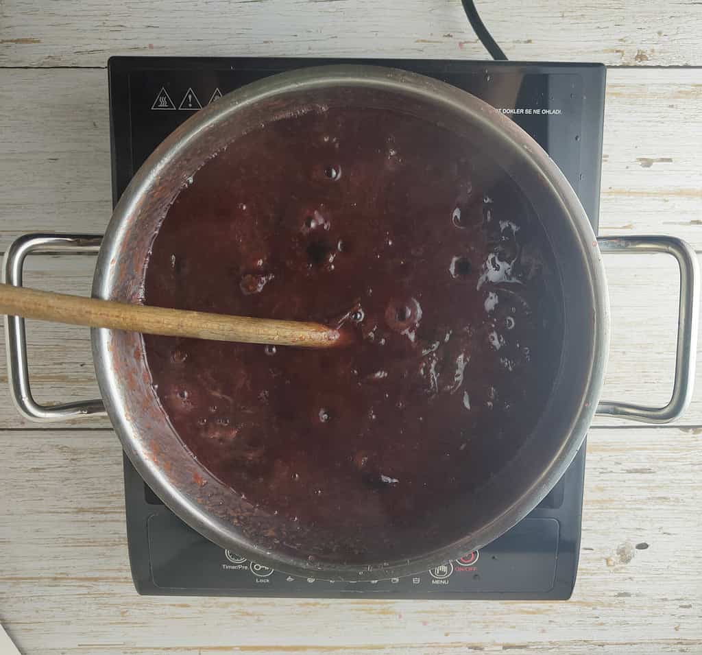 simmering plum jam with cinnamon